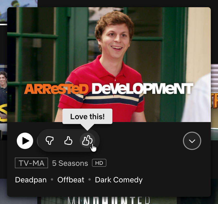 A TV show preview card in Netflix, where the rating menu is toggled open. It has A thumb's down icon, a thumb's up icon, and a double thumb's up icon. The double thumb's up icon has a mouse cursor hovering over it, revealing a tooltip that reads, 'Love this!' The TV show is Arrested Development, and the hero image is Michael Cera as George-Michael Bluth with his trademark happy-yet-confused expression. Cropped screenshot.