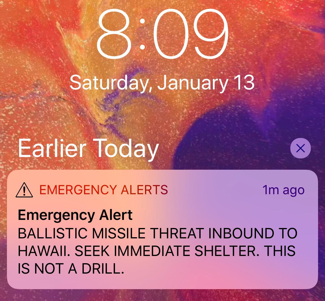 The top half of an iPhone lock screen. A notification is present, and it reads 'Emergency alerts, 1 minute ago. Emergency Alert. Ballistic missile threat inbound to Hawaii. Seek immediate shelter. This is not a drill.' The time is 8:09 AM, and the date is Saturday, January 13th.